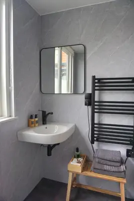 a bathroom with a sink and a mirror at 1 aan Strand in Egmond aan Zee