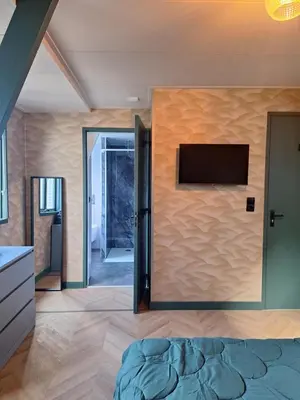 a room with a wall with a flat screen tv at 1 aan Duin in Egmond aan Zee