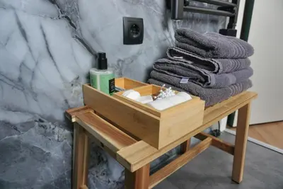 a wooden table with a soap dispenser and towels at 1 aan Duin in Egmond aan Zee
