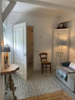 a bedroom with a bed and a table and a chair at De Vink Bed & Breakfast in Abcoude