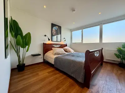 a bedroom with a bed and a potted plant at Holiday Home Vijfhuizen 2pers in Vijfhuizen