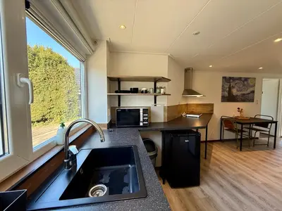 a kitchen with a sink and a large window at Holiday Home Vijfhuizen 2pers in Vijfhuizen