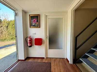 a hallway with a fire extinguisher on the door at Holiday Home Vijfhuizen 2pers in Vijfhuizen