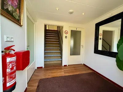 a hallway with a red fire hydrant and a mirror at Holiday Home Vijfhuizen 2pers in Vijfhuizen