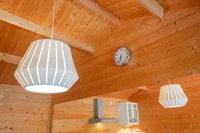a room with two lights and a clock on the ceiling at Chalet Zandvoort in Zandvoort