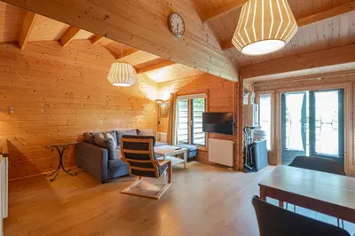 a living room with a couch and a table at Chalet Zandvoort in Zandvoort
