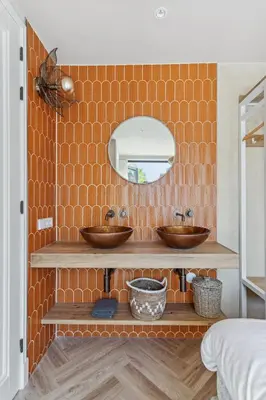 a bathroom with two sinks and a mirror at STONEBRIDGE boutique apartments - City centre in Alkmaar