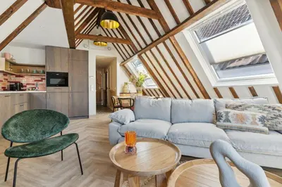 a living room with a couch and a table at STONEBRIDGE boutique apartments - City centre in Alkmaar