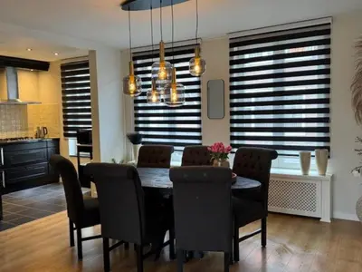 a kitchen and dining room with a table and chairs at Sunny Beach in Zandvoort