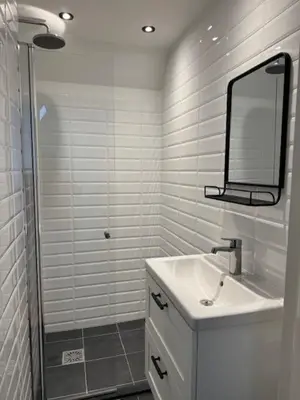 a white bathroom with a sink and a mirror at Sunny Beach in Zandvoort