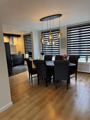a dining room and kitchen with a table and chairs at Sunny Beach in Zandvoort