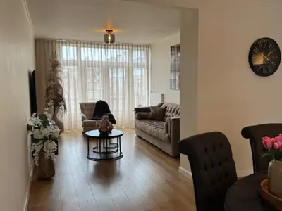 a living room with a couch and a table at Sunny Beach in Zandvoort