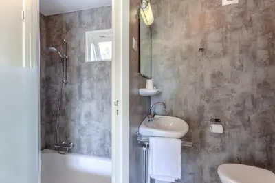 a bathroom with a sink and a toilet and a shower at Hajé Restaurant de Aalscholver in Lelystad