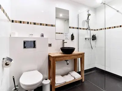 a bathroom with a sink and a toilet and a shower at Hajé Restaurant de Aalscholver in Lelystad