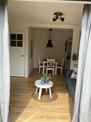 a living room with a couch and a table at Zomerhuis aan Zee in Zandvoort