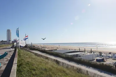 a view of a beach with people and the ocean at Zomerhuis aan Zee in Zandvoort
