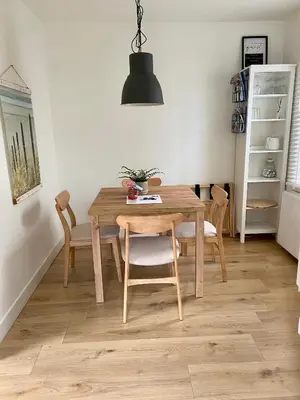 a dining room with a wooden table and chairs at Zomerhuis aan Zee in Zandvoort
