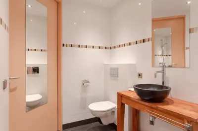 a bathroom with a sink and a toilet at Hajé Hotel Restaurant de Lepelaar in Lelystad