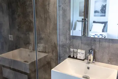 a bathroom with a sink and a shower at Hajé Hotel Restaurant de Lepelaar in Lelystad