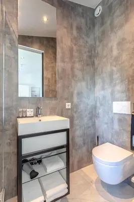 a bathroom with a sink and a toilet at Hajé Hotel Restaurant de Lepelaar in Lelystad