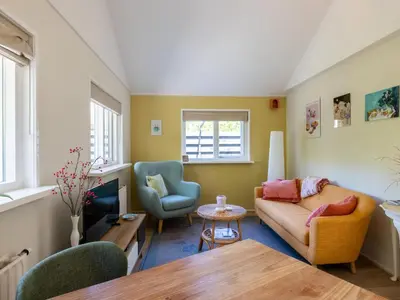 a living room with a couch and a table at De Groeter Lodge in Groet