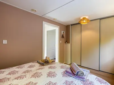 a bedroom with a bed with two pillows on it at De Groeter Lodge in Groet