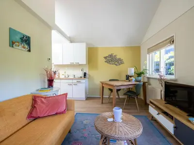 a living room with a couch and a table at De Groeter Lodge in Groet