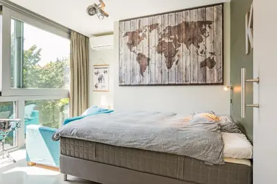a bedroom with a bed with a map on the wall at Villa Red Cedar in Bergen