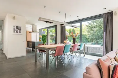 a kitchen and dining room with a table and chairs at Villa Red Cedar in Bergen