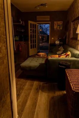 a living room with a couch and a window at Wellness oase Egmond in Egmond aan den Hoef