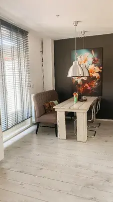 a living room with a table and a couch at Charming Entire Home Near Amsterdam in Hilversum