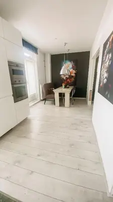 a living room with a kitchen and a table at Charming Entire Home Near Amsterdam in Hilversum