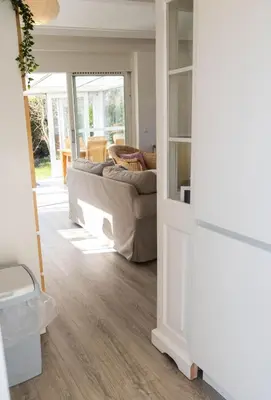 a living room with a couch and a table at Zeemeeuw in Egmond aan den Hoef
