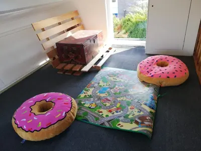 two donuts sitting on the floor next to a rug at Zeemeeuw in Egmond aan den Hoef