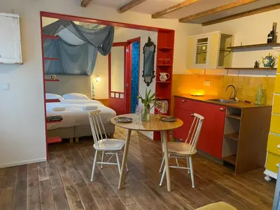 a room with a kitchen and a table and chairs at charming studio in Amsterdam-Noord in Amsterdam