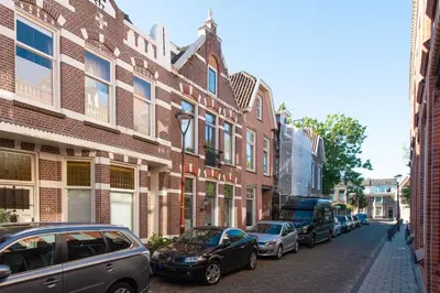 a row of cars parked on a street next to buildings at Casa Hofdijkstraat in Alkmaar