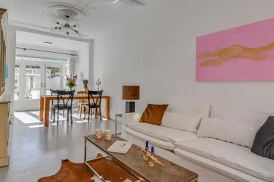 a living room with a white couch and a table at Casa Hofdijkstraat in Alkmaar