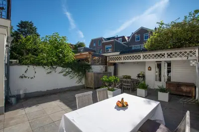 a table with bananas on it on a patio at Casa Hofdijkstraat in Alkmaar