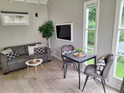 a living room with a couch and a table at Park De Driesprong in Nieuwveen