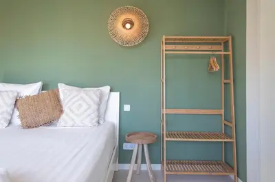 a bedroom with a bed and a ladder next to a shelf at Smile Studio's in Zandvoort