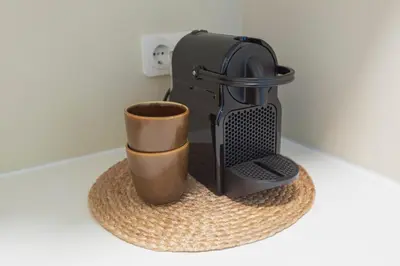 a coffee maker and a cup sitting on a towel at Smile Studio's in Zandvoort