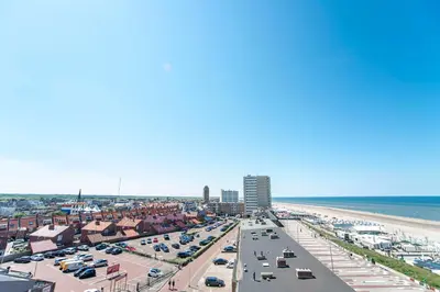 an aerial view of a beach with cars parked at Smile Studio's in Zandvoort