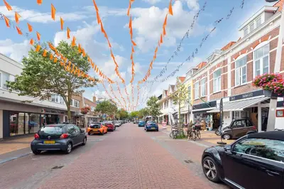 a city street with cars parked on the street at Smile Studio's in Zandvoort