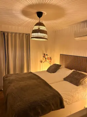a bedroom with a large bed and a ceiling at Beachhouse Wijk aan Zee! in Wijk aan Zee
