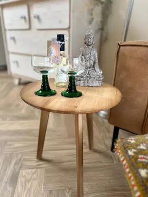 a table with two glasses and a statue on it at Beachhouse Wijk aan Zee! in Wijk aan Zee