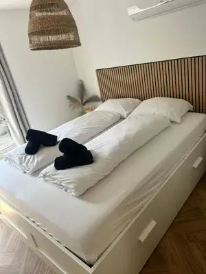 a bed with two teddy bears sitting on it at Beachhouse Wijk aan Zee! in Wijk aan Zee
