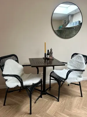 a dining room table with two chairs and a mirror at Beachhouse Wijk aan Zee! in Wijk aan Zee