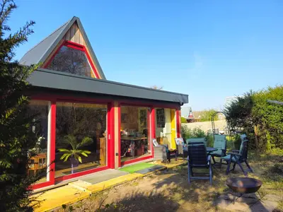 a small house with a red trim and windows at Heidy's Home, with Wellness Facilities in Zeewolde