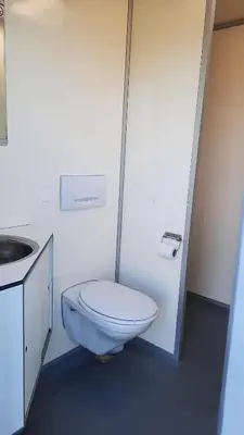 a white bathroom with a toilet and a sink at De Rozenbottel met privé sanitair in Hensbroek