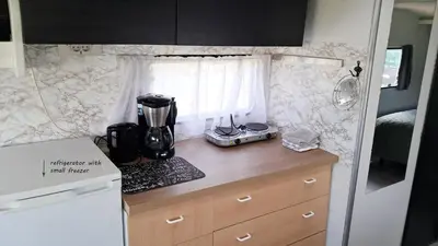 a kitchen in an rv with a blender on a counter at De Rozenbottel met privé sanitair in Hensbroek